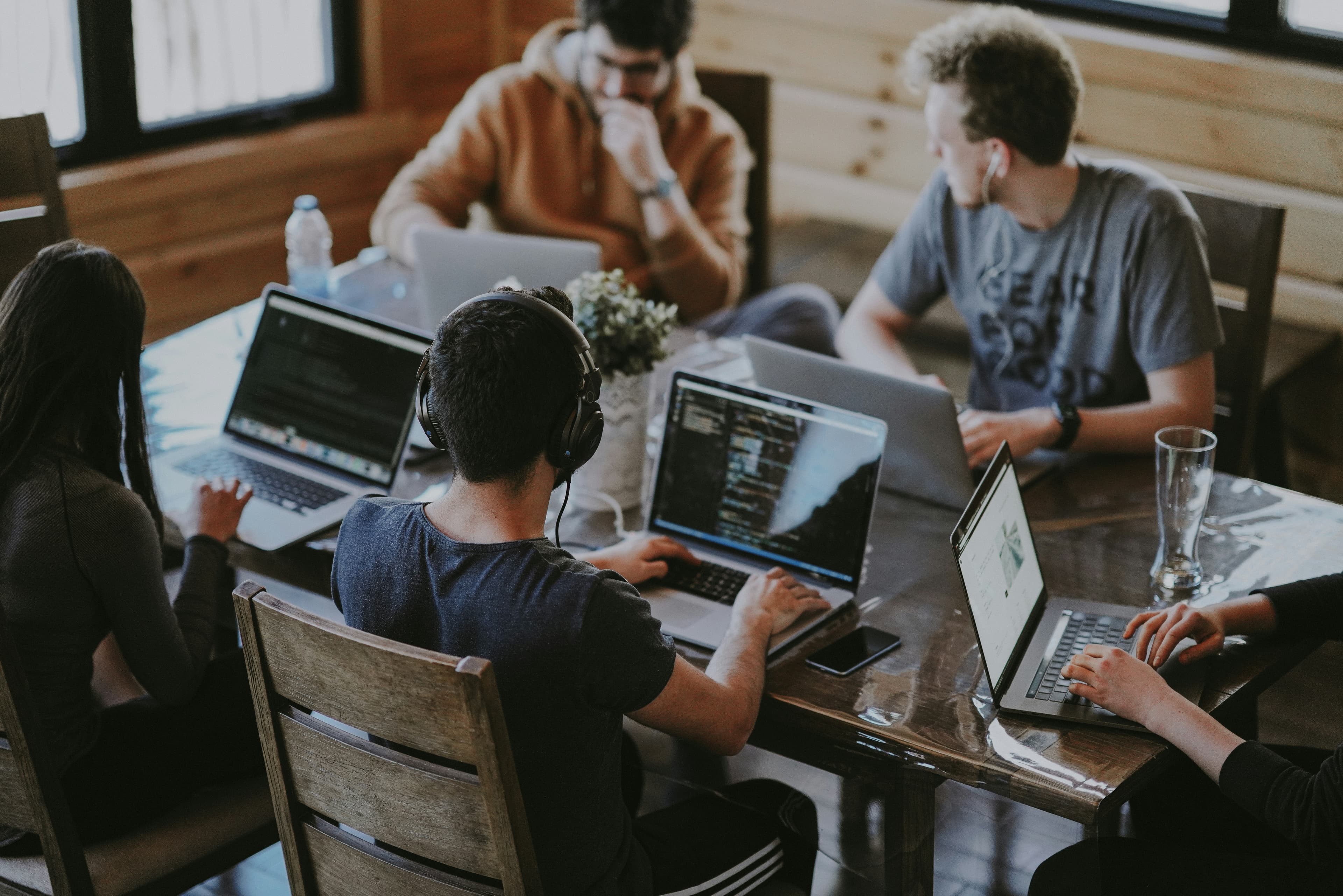 Diverse remote team collaborating across laptops during a video conference
