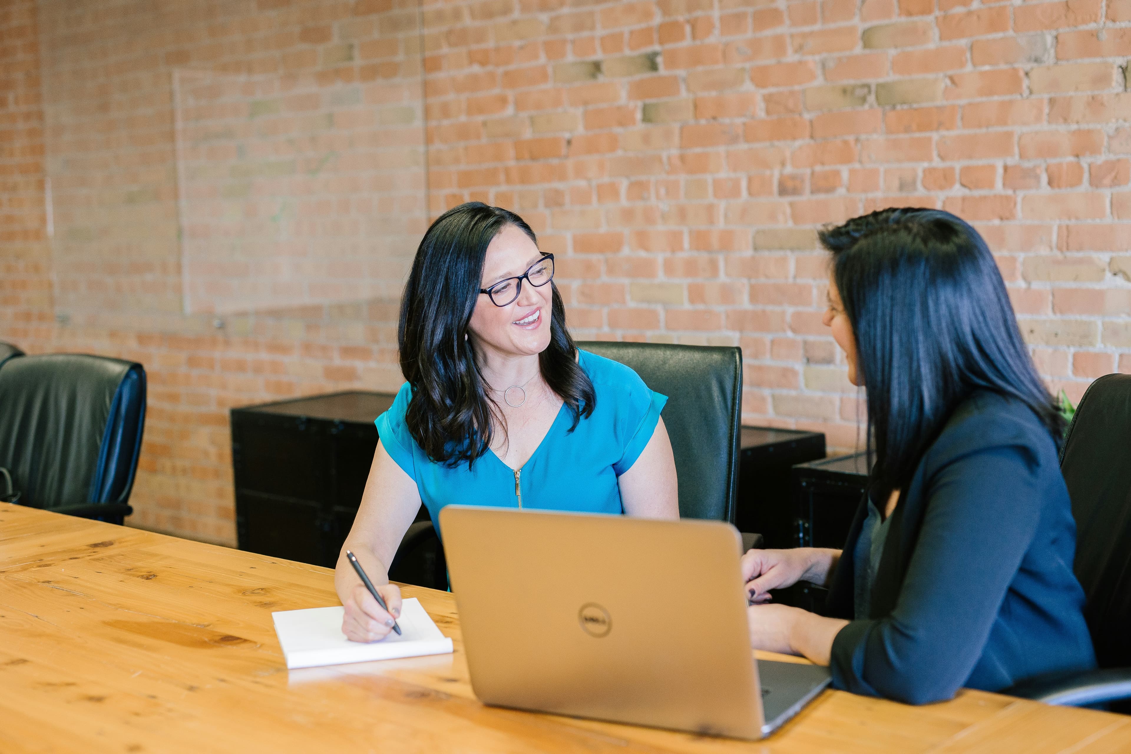 Business professionals conducting a technical and operational review across laptops