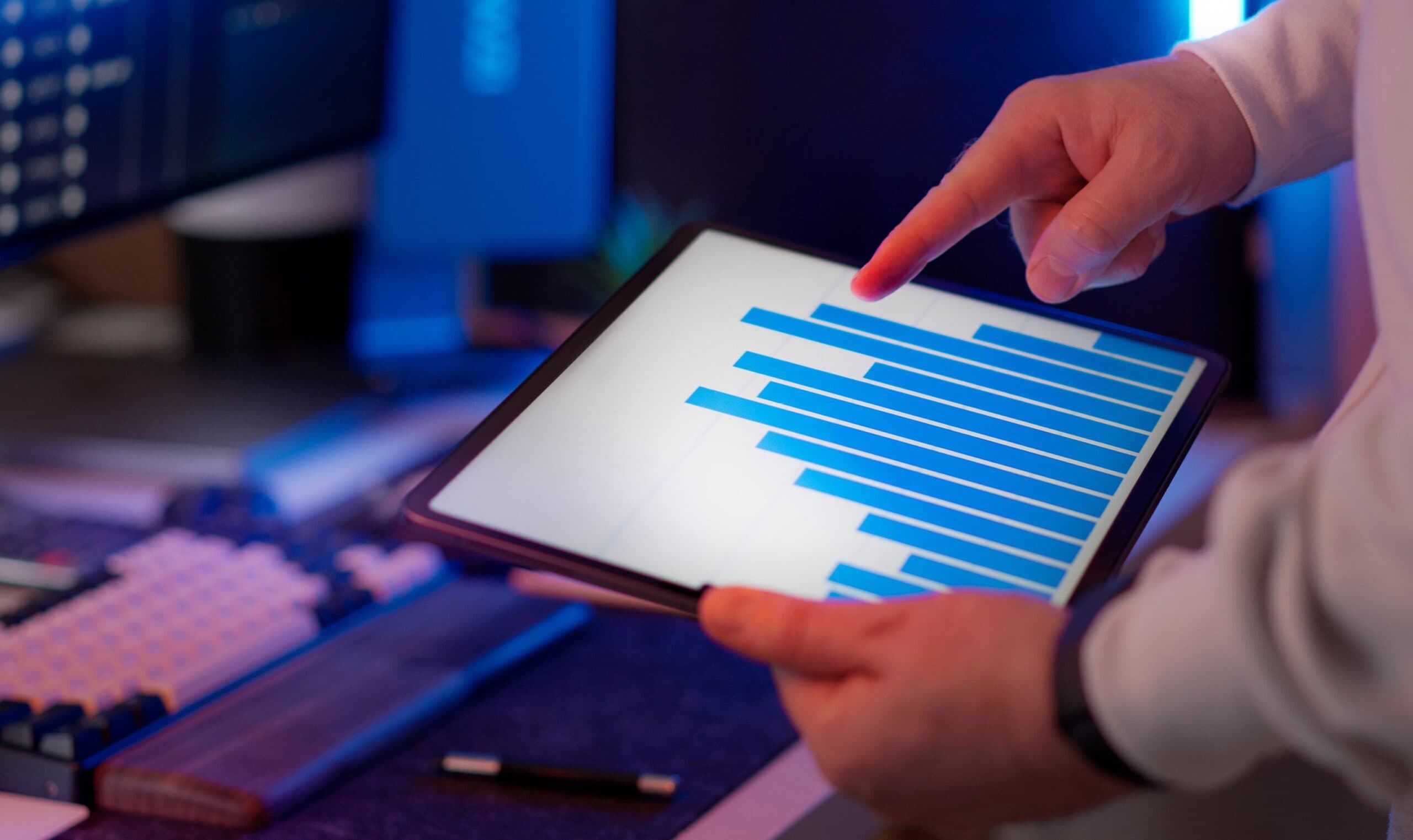 Person calculating business costs on a laptop with charts